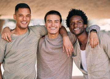 friends-together-portrait-men-outdoor-with-hug-relax-happy-with-diversity-smile-freedom-friendship-care-bonding-with-solidarity-support-young-people-with-bond-trust